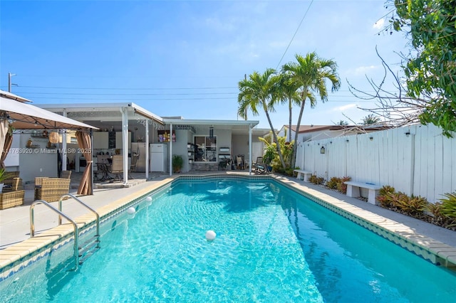 view of swimming pool with a patio, fence, and a fenced in pool