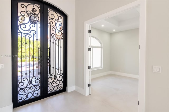 foyer with recessed lighting, french doors, and baseboards