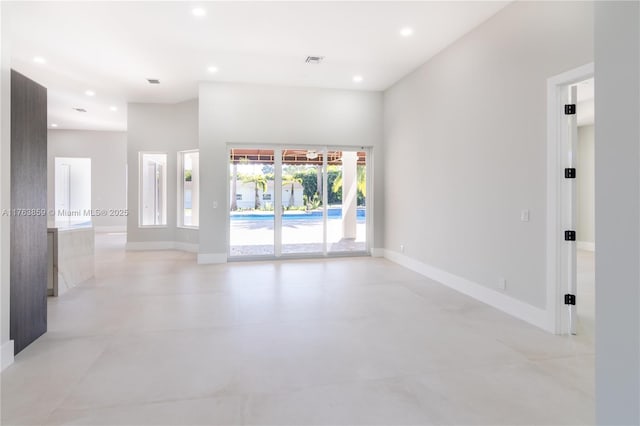 empty room with visible vents, recessed lighting, and baseboards