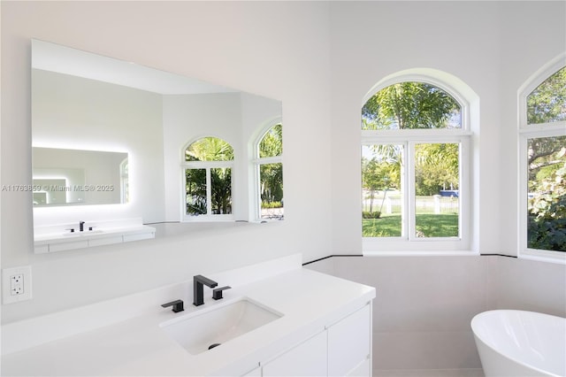 bathroom featuring vanity and a soaking tub