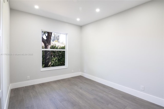 unfurnished room featuring recessed lighting, baseboards, and wood finished floors