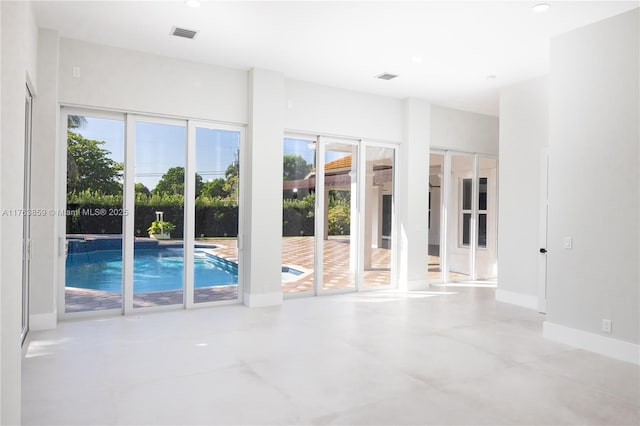 unfurnished room featuring visible vents and baseboards