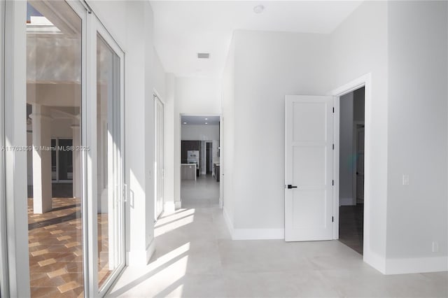 corridor featuring visible vents and baseboards