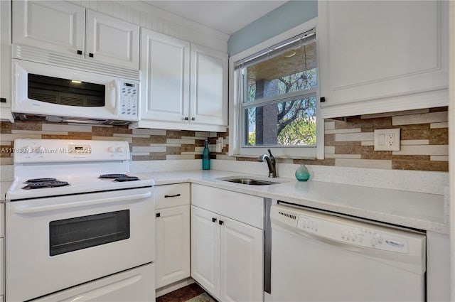 kitchen featuring a sink, white appliances, tasteful backsplash, and white cabinetry