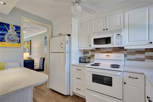 kitchen with white appliances, white cabinets, light countertops, and backsplash