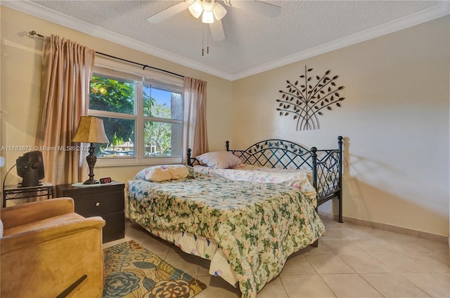 bedroom with a ceiling fan, a textured ceiling, crown molding, light tile patterned floors, and baseboards