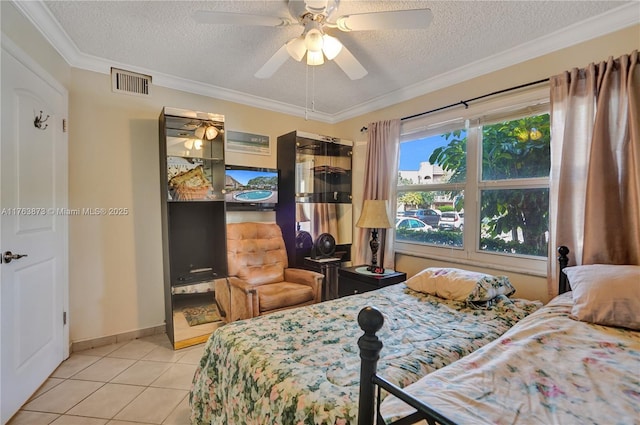 bedroom with visible vents, crown molding, ceiling fan, tile patterned floors, and a textured ceiling