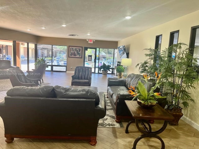 living room with baseboards and a textured ceiling