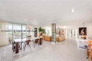 dining area featuring a chandelier and expansive windows