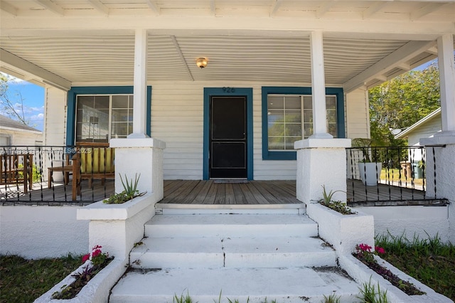 view of exterior entry with covered porch