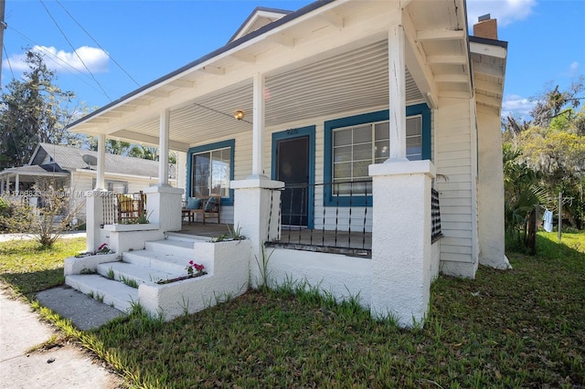 exterior space featuring a porch and a chimney