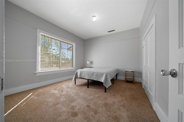 bedroom featuring baseboards, carpet floors, and visible vents