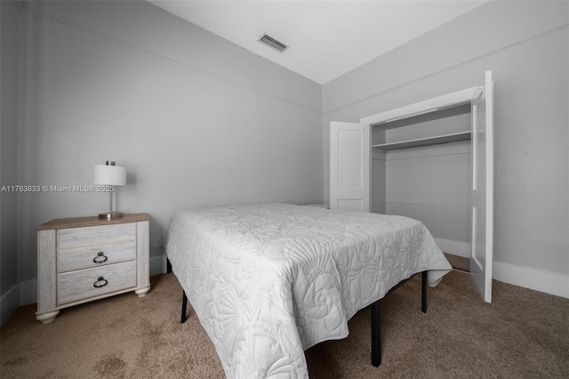 carpeted bedroom featuring visible vents, lofted ceiling, and a closet