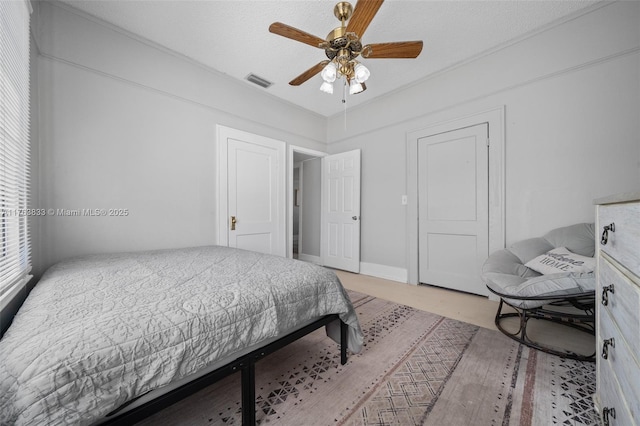 bedroom featuring visible vents and a ceiling fan