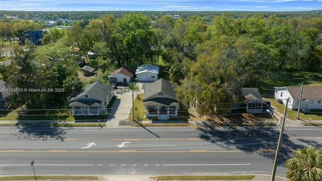 birds eye view of property featuring a view of trees