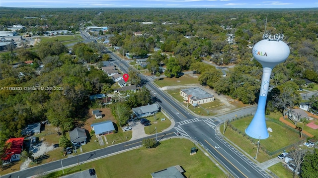 birds eye view of property featuring a wooded view