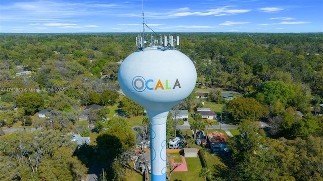 birds eye view of property featuring a view of trees