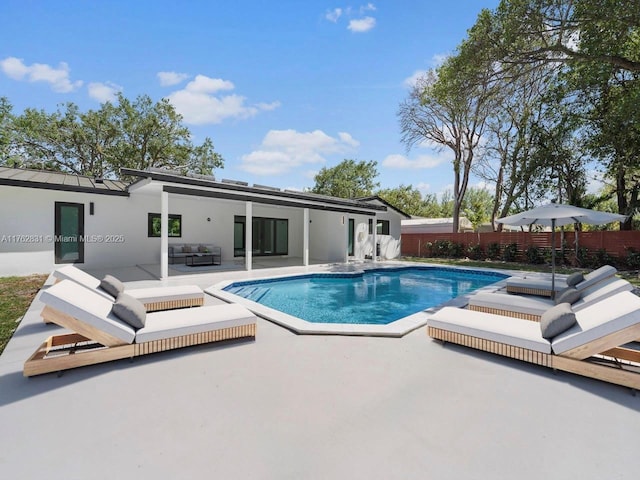 view of swimming pool featuring a patio area, an outdoor living space, a fenced in pool, and fence