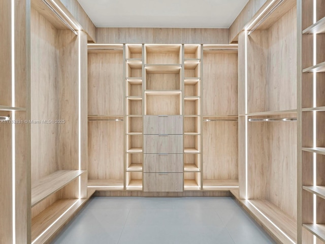 walk in closet with tile patterned floors