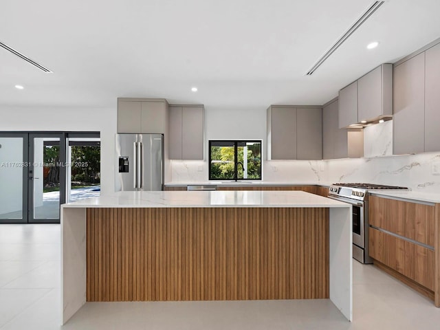 kitchen featuring appliances with stainless steel finishes, gray cabinetry, and modern cabinets