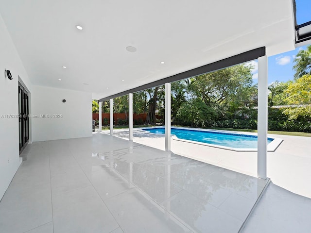 view of swimming pool with a fenced in pool, fence, and a patio area