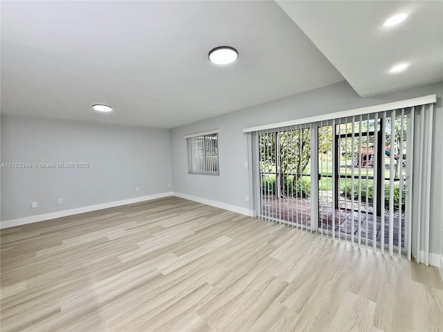 unfurnished room featuring recessed lighting, baseboards, and light wood finished floors