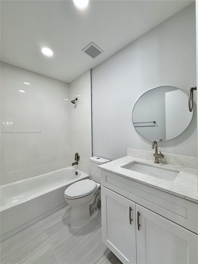 bathroom with vanity, toilet, washtub / shower combination, and visible vents