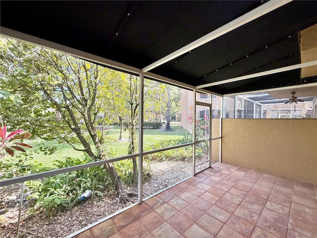 unfurnished sunroom with a ceiling fan