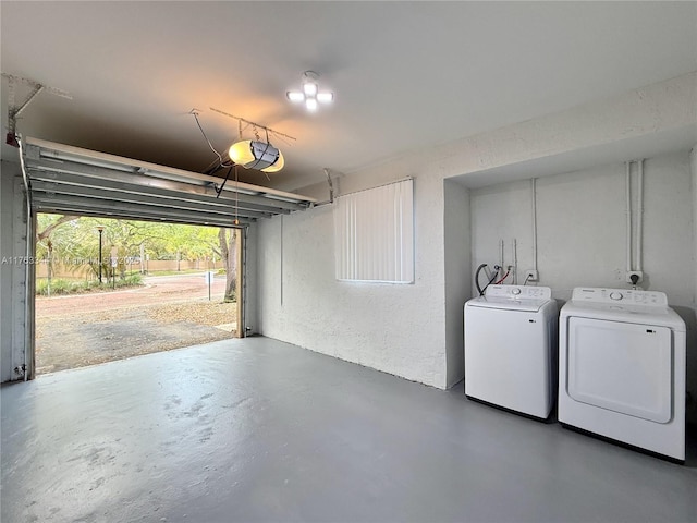 garage with a garage door opener and washing machine and clothes dryer