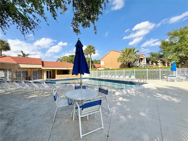 pool featuring a patio and fence