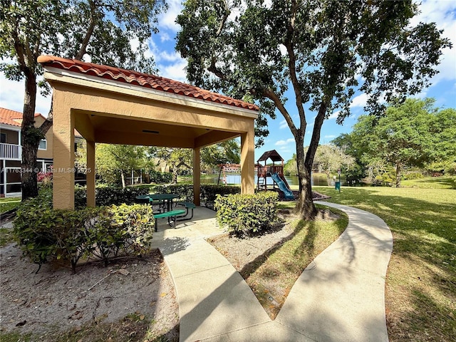 view of property's community with a gazebo, a lawn, and playground community