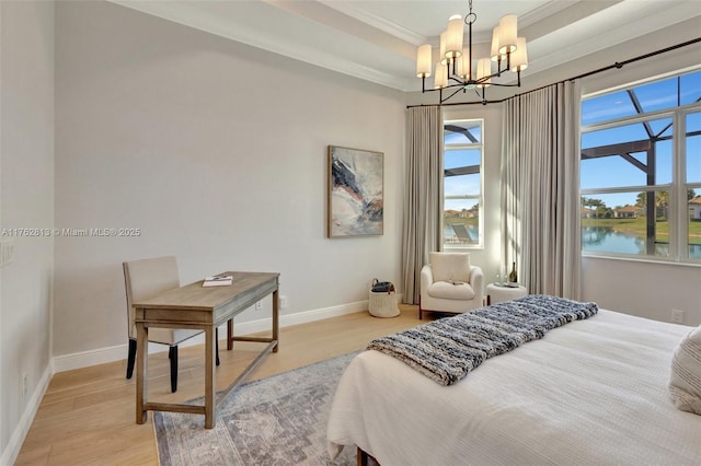 bedroom featuring a notable chandelier, baseboards, a raised ceiling, and light wood-style floors