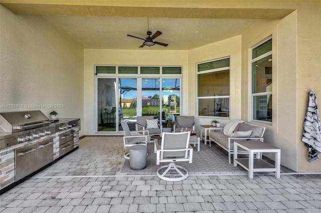 view of patio with outdoor lounge area, exterior kitchen, and a ceiling fan