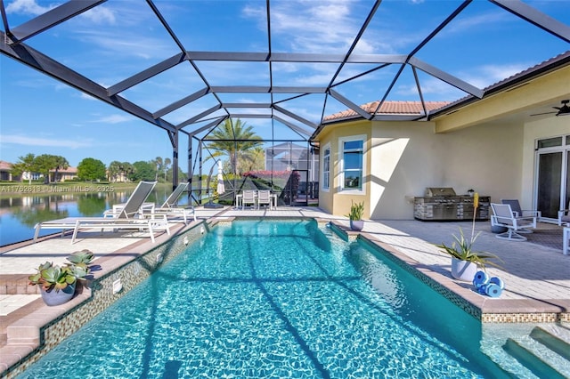 outdoor pool featuring a water view, a lanai, a patio, an outdoor kitchen, and a ceiling fan