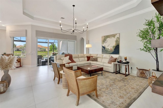 living room featuring visible vents, a raised ceiling, baseboards, and ornamental molding