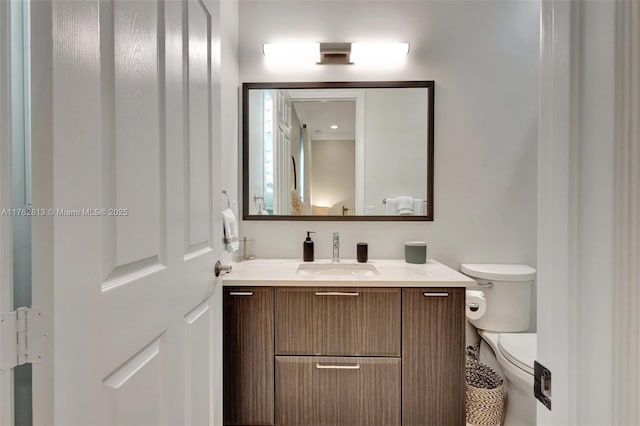 bathroom featuring toilet and vanity