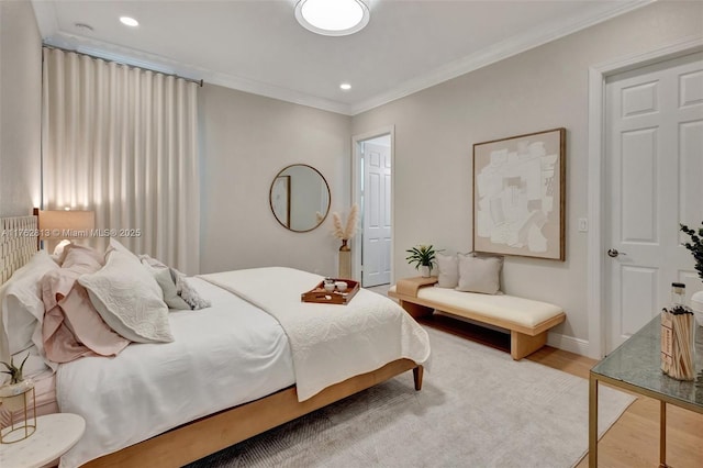 bedroom featuring recessed lighting, ornamental molding, baseboards, and wood finished floors