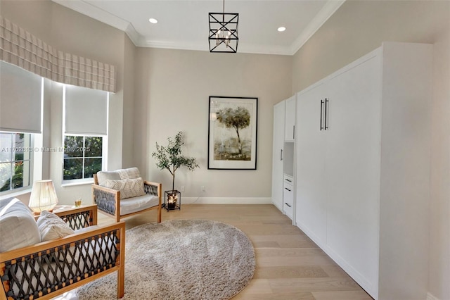 living area featuring light wood finished floors, recessed lighting, baseboards, and ornamental molding