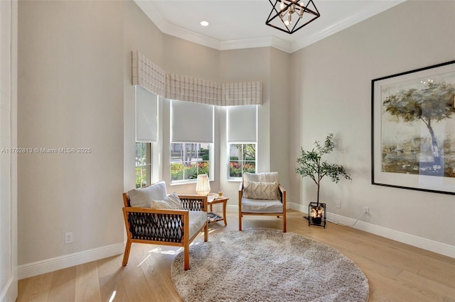 living area featuring wood finished floors, baseboards, and ornamental molding