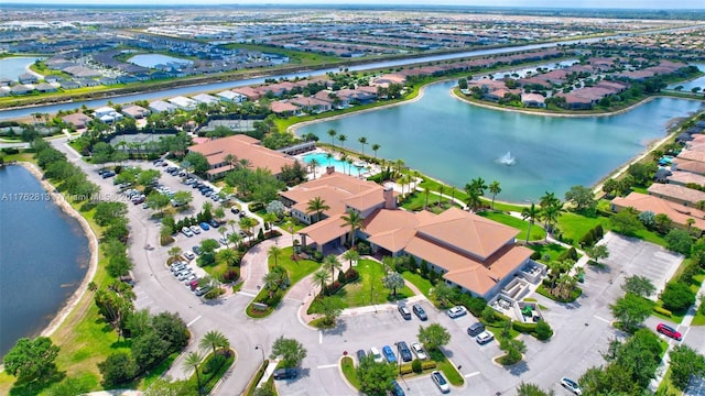 drone / aerial view featuring a residential view and a water view