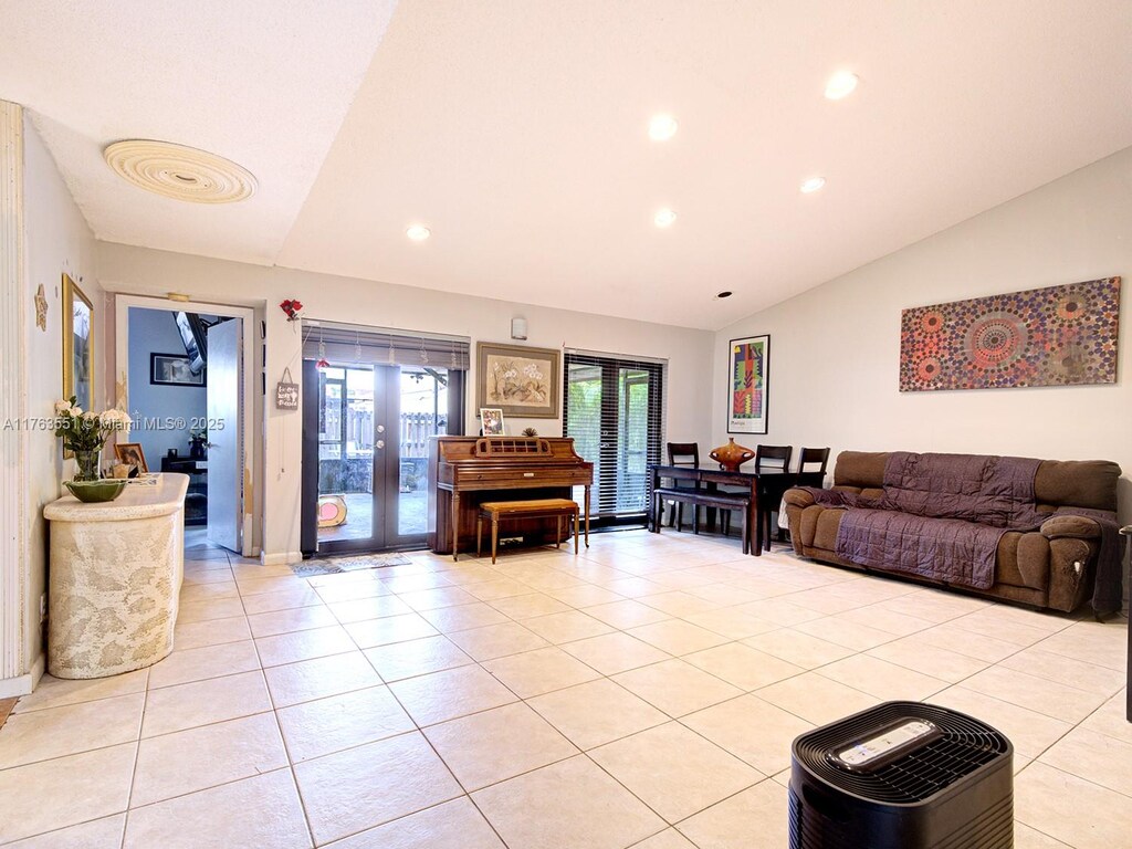 6240 NW 176th Ter, Hialeah, FL 33015 - living room with recessed lighting, vaulted ceiling, french doors, and light tile patterned floors