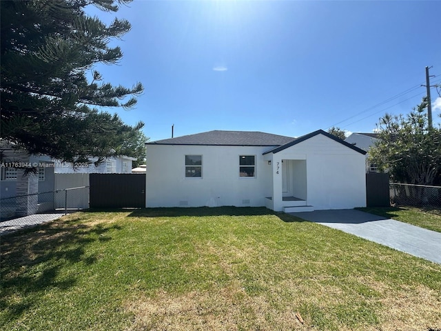 rear view of property featuring crawl space, a yard, and fence