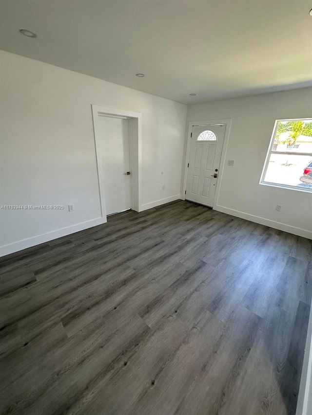 entryway with baseboards and dark wood-style flooring