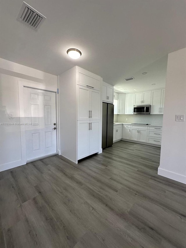 kitchen with visible vents, white cabinets, appliances with stainless steel finishes, and dark wood-style flooring