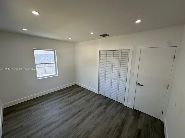 unfurnished bedroom with recessed lighting, visible vents, and dark wood-type flooring