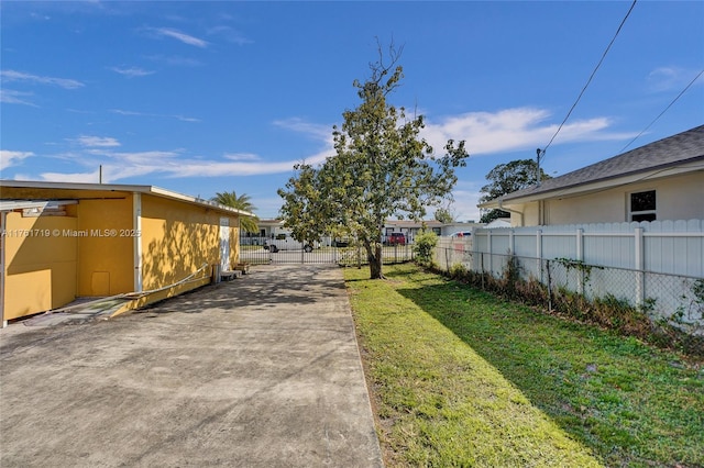 view of road featuring concrete driveway and a gated entry