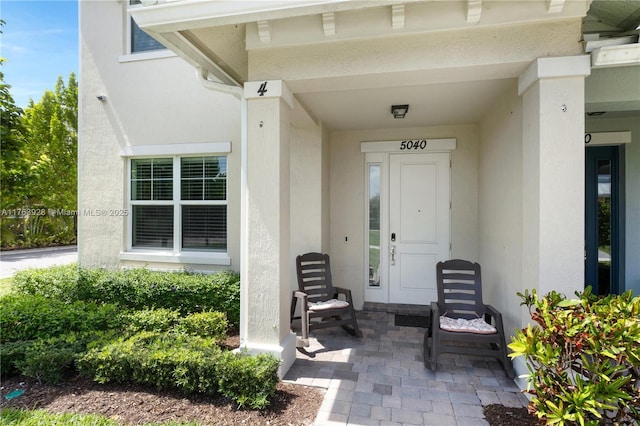 view of exterior entry with stucco siding