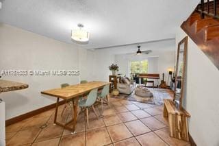 tiled dining area with stairs, baseboards, and ceiling fan