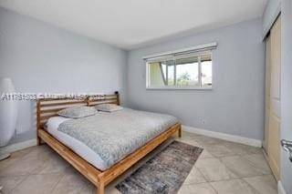 tiled bedroom with baseboards