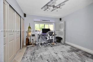 office featuring a notable chandelier and baseboards